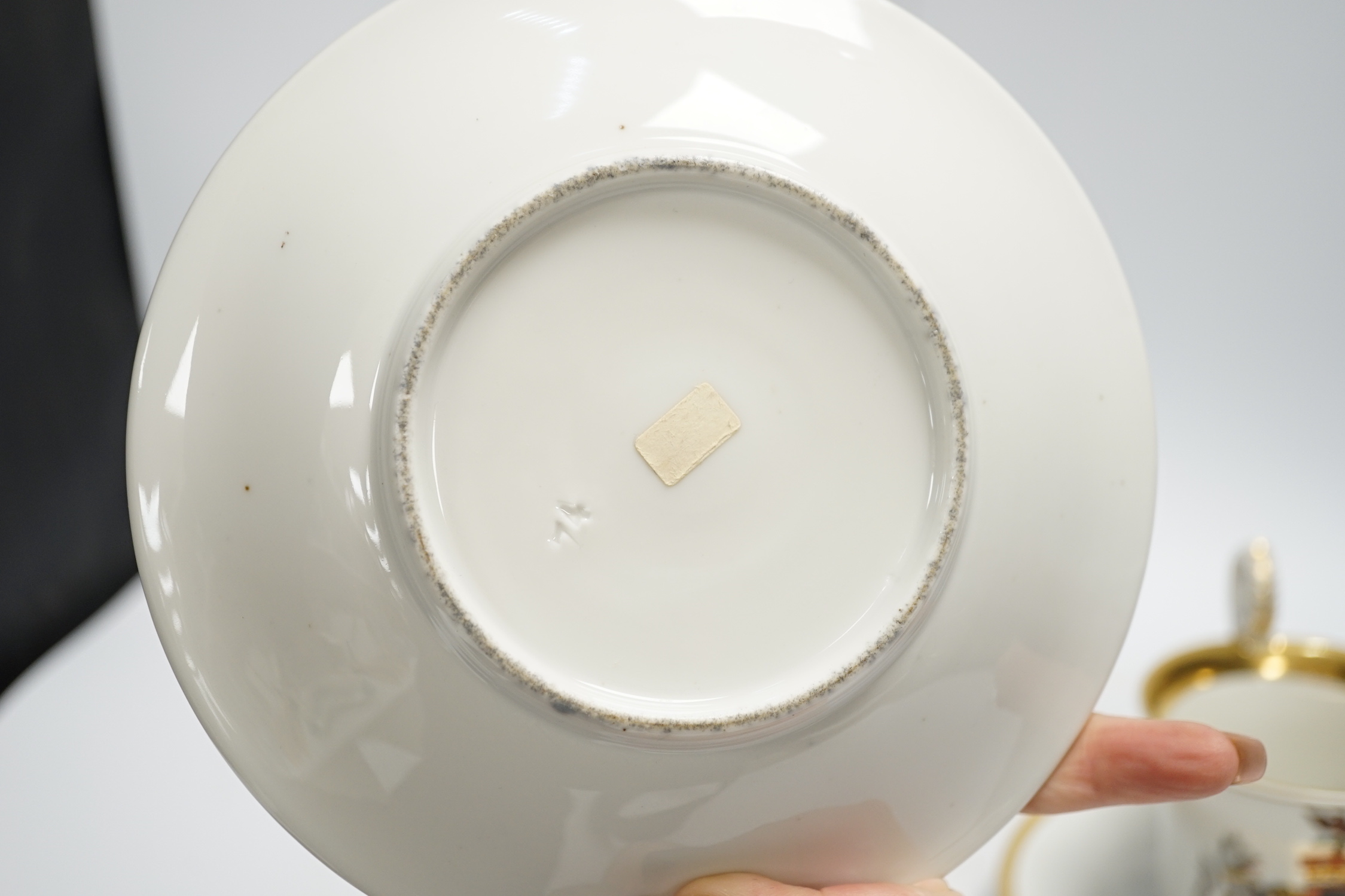 A pair of German porcelain armorial cups and saucers, one saucer reads ‘Lord Bingham s/m Y. Powell. Born 1848’
